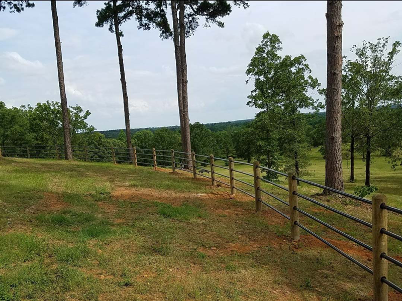decorative fence on a hill overlooking a scenic valley